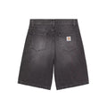 Back view of dark gray washed denim shorts with a visible Carhartt logo patch on the back pocket, set against a solid gray background.