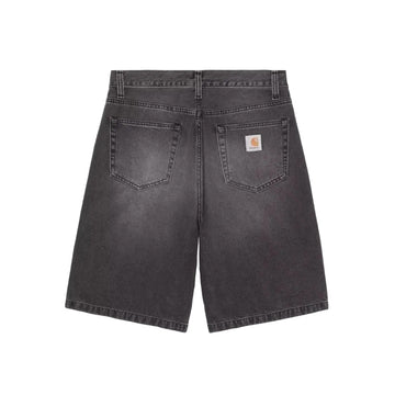 Back view of dark gray washed denim shorts with a visible Carhartt logo patch on the back pocket, set against a solid gray background.