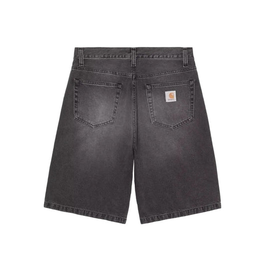 Back view of dark gray washed denim shorts with a visible Carhartt logo patch on the back pocket, set against a solid gray background.
