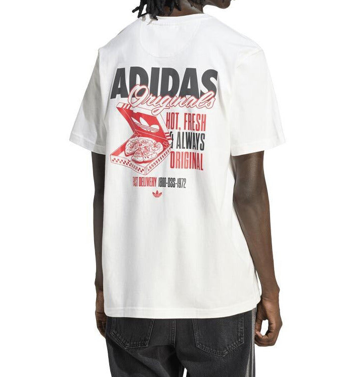 A model from behind wearing a white Adidas Originals t-shirt with a large red and black graphic print on the back, paired with dark gray track pants against a white background.