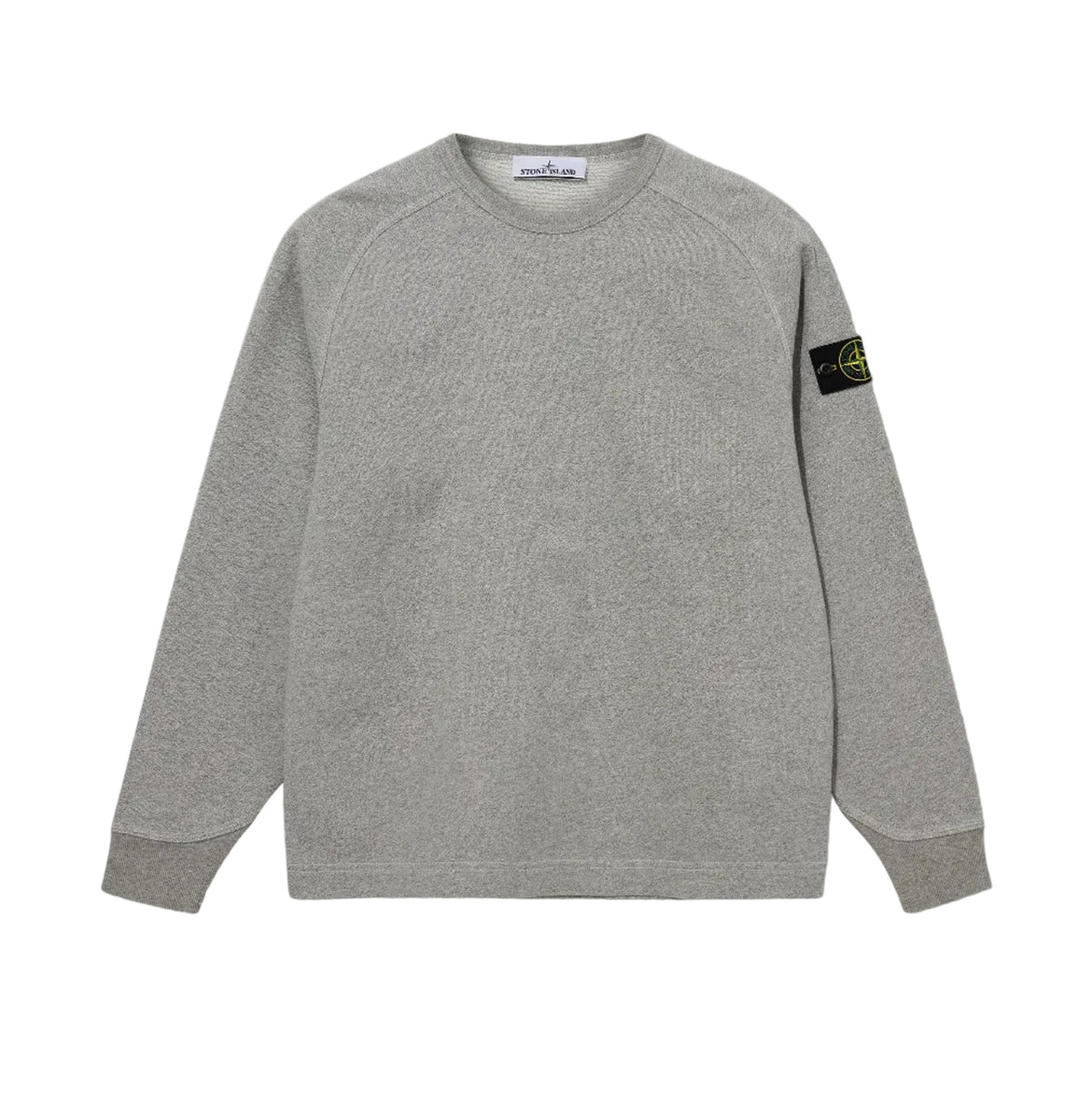 A light gray heather crewneck sweatshirt with raglan sleeves, featuring the black and yellow Stone Island compass patch on the left sleeve, displayed against a neutral light gray background.
