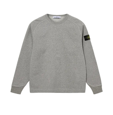 A light gray heather crewneck sweatshirt with raglan sleeves, featuring the black and yellow Stone Island compass patch on the left sleeve, displayed against a neutral light gray background.