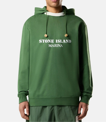 Person wearing a green Stone Island hoodie on a white background