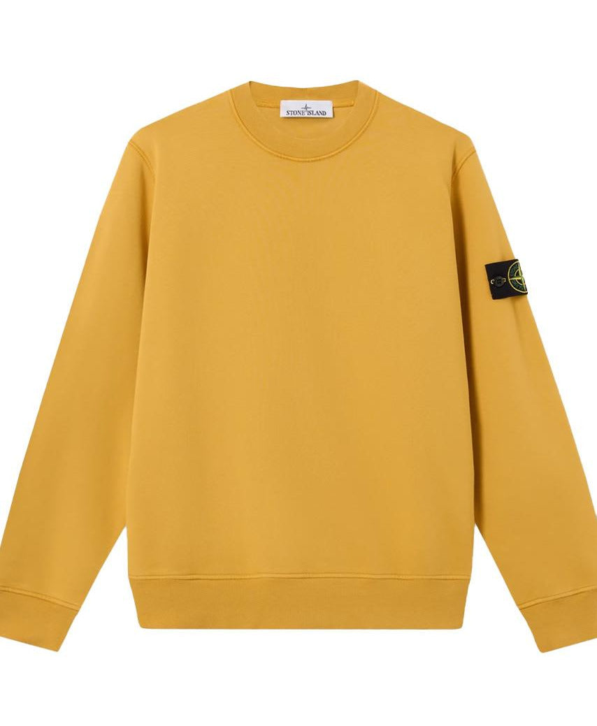 A yellow crewneck sweatshirt with a Stone Island compass patch on the left sleeve, displayed against a plain white background.