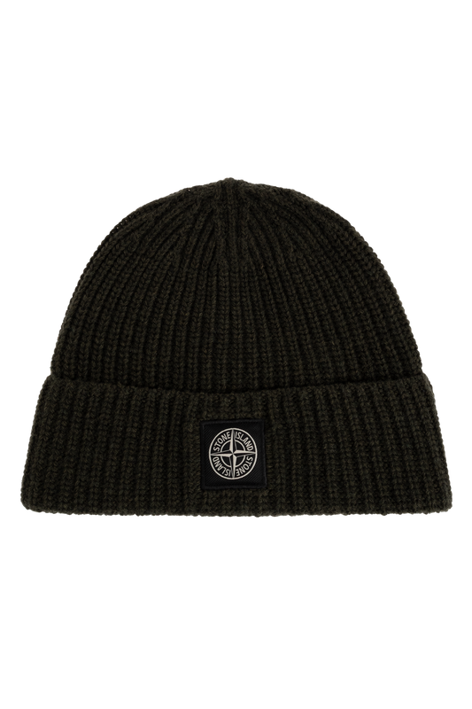 A black ribbed knit beanie hat featuring a small black square patch on the front cuff with the circular Stone Island compass logo. 