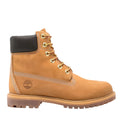 A classic Timberland 6-inch work boot in tan suede, featuring a black collar, gold metal eyelets, and the signature embossed tree logo on the side, set against a plain light gray background.