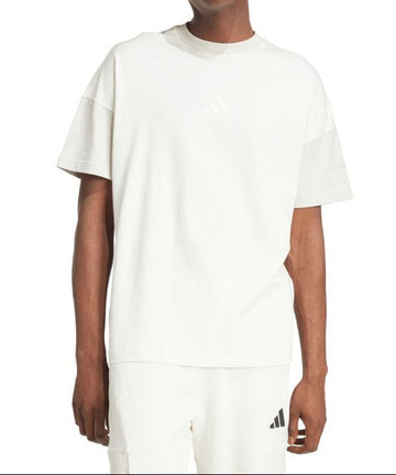 Person wearing a white t-shirt and pants with Adidas logo on a white background