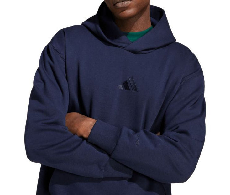 Person wearing a navy blue hoodie on a white background