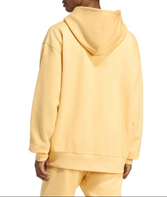 Person wearing a yellow hoodie and pants on a white background