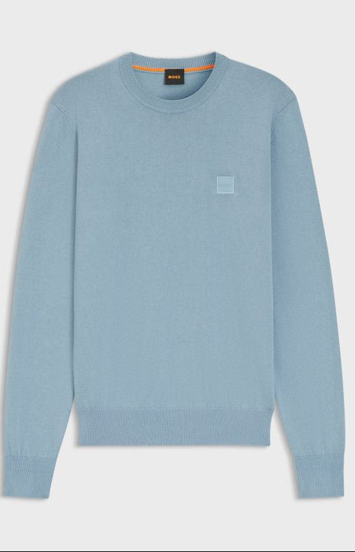 Light blue sweater with a small logo on a white background