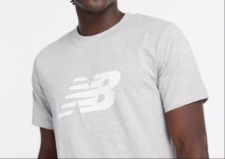Person wearing a gray New Balance t-shirt on a white background
