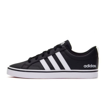 Black Adidas sneaker with white stripes on a white background