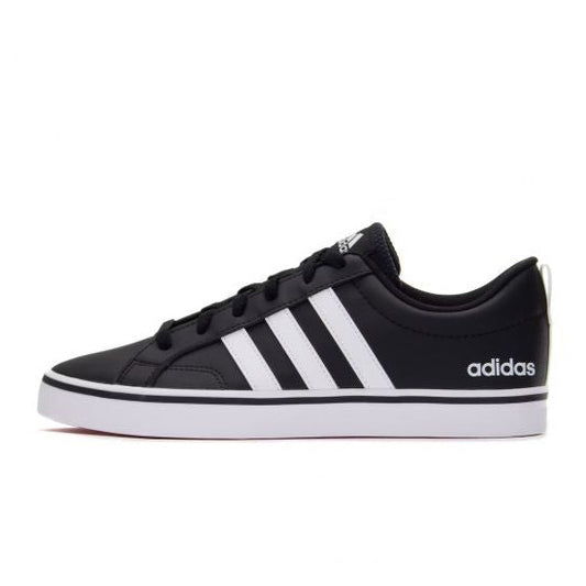 Black Adidas sneaker with white stripes on a white background