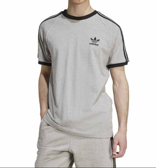 Person wearing a gray Adidas t-shirt with black accents on a white background