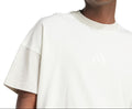 Person wearing a plain white t-shirt on a white background