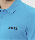 Blue polo shirt with 'BOSS' logo worn by a person on a white background