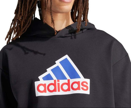 Person wearing a black Adidas hoodie with the brand logo on a white background