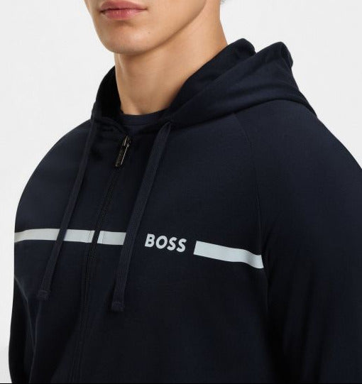 Man wearing a navy hoodie with 'BOSS' logo on a light gray background