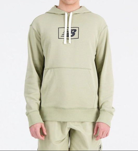 Person wearing a light green hoodie with a logo on a white background