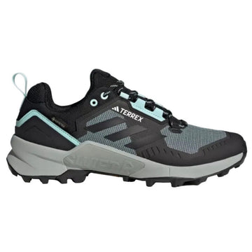 Black and gray Adidas Terrex sneaker with teal accents on a light gray background