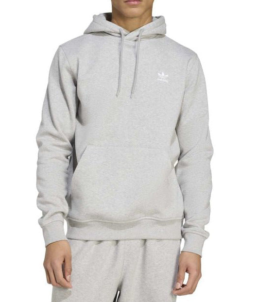 Person wearing a gray Adidas hoodie on a white background