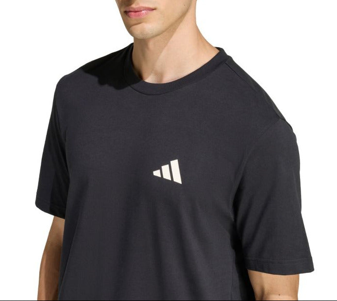 Person wearing a black Adidas t-shirt on a white background