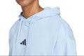 Person wearing a light blue hoodie with a brand logo on a white background