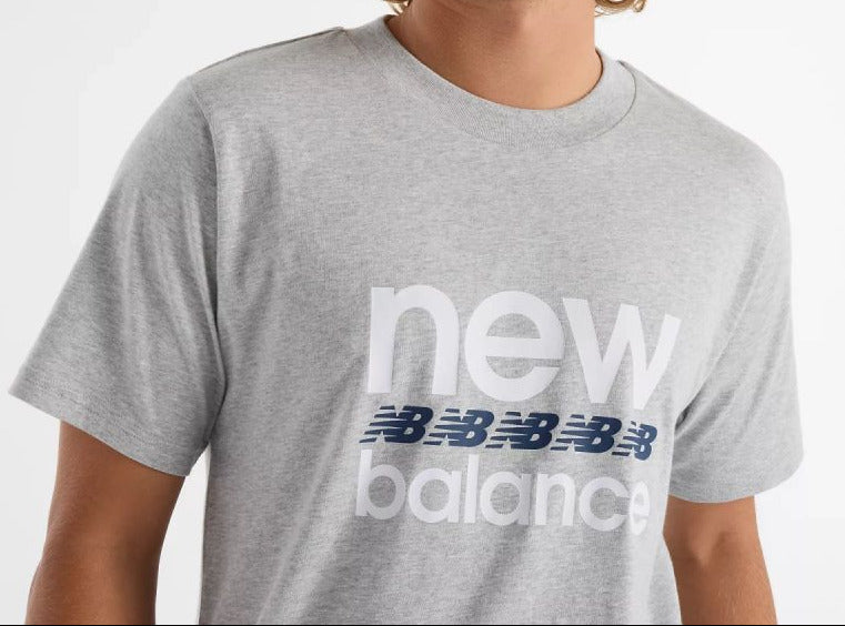 Person wearing a gray New Balance t-shirt on a white background