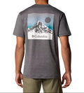 Person wearing a gray Columbia t-shirt with a mountain graphic on the back