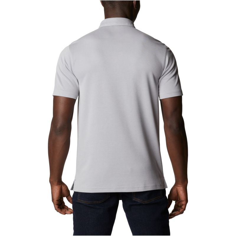 Person wearing a white polo shirt on a white background