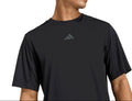A man wearing a black Adidas athletic t-shirt with a dark gray logo on the chest, shown from the waist up against a plain white background.