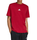 Person wearing a red Adidas t-shirt on a white background