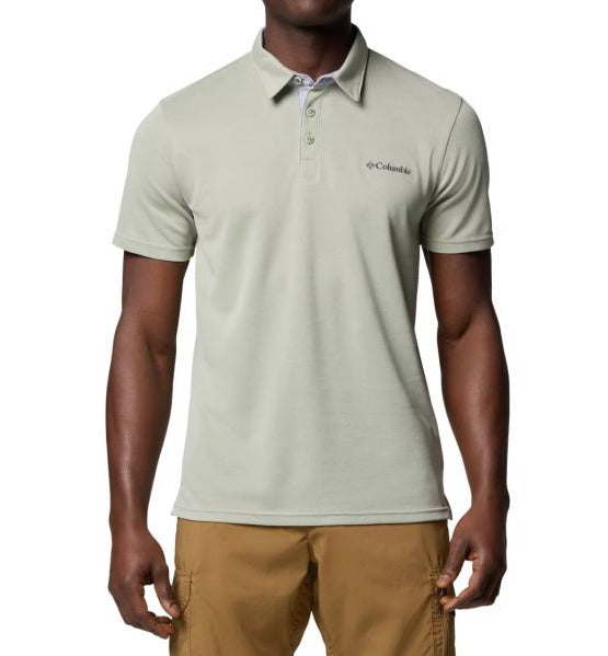 Man wearing a light green Columbia polo shirt on a white background