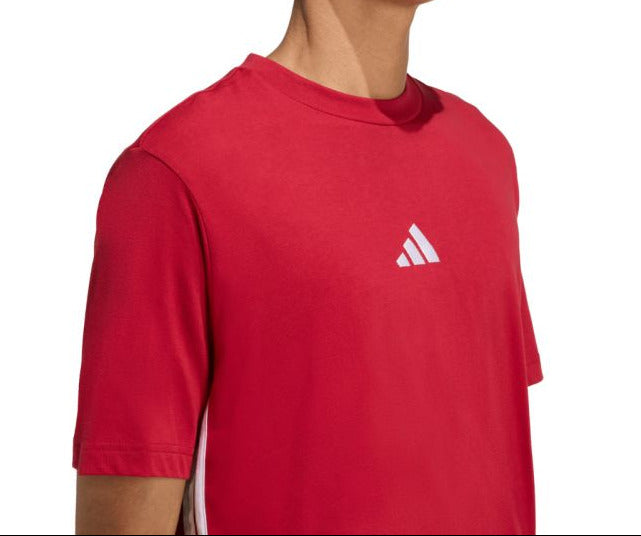 Person wearing a red Adidas t-shirt on a white background
