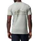 Person wearing a light gray Columbia t-shirt with a mountain graphic on the back.