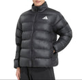 A man wearing a black Adidas puffer jacket with a white logo on the chest, photographed against a solid white background.