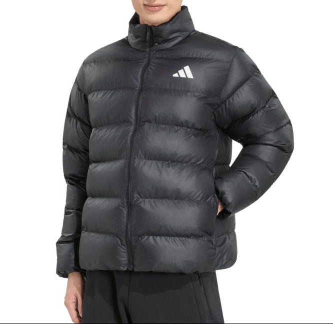 A man wearing a black Adidas puffer jacket with a white logo on the chest, photographed against a solid white background.