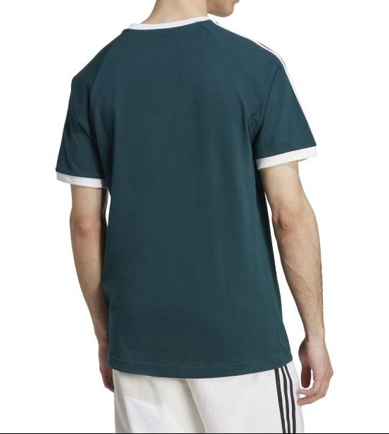 Person wearing a dark green t-shirt with white trim on a white background