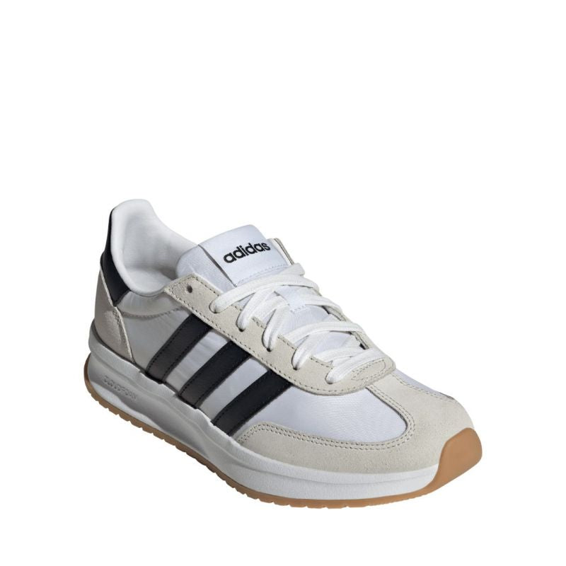 White Adidas sneaker with black stripes on a white background
