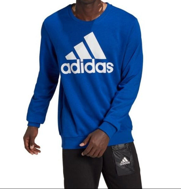 Person wearing a blue Adidas sweatshirt on a white background