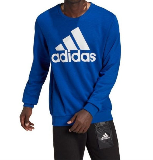 Person wearing a blue Adidas sweatshirt on a white background
