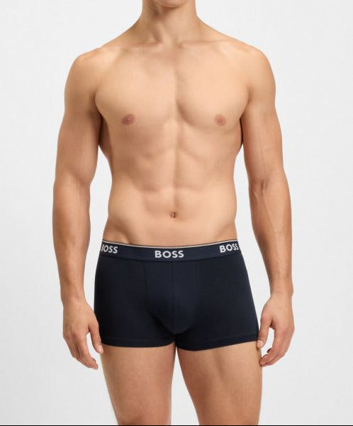 Man wearing black boxer briefs with 'BOSS' branding on a white background