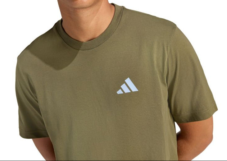 Person wearing an Adidas t-shirt on a white background