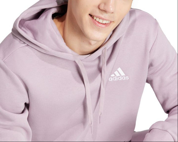 Person wearing a light purple Adidas hoodie on a white background