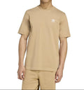Person wearing a beige Adidas t-shirt and pants on a white background