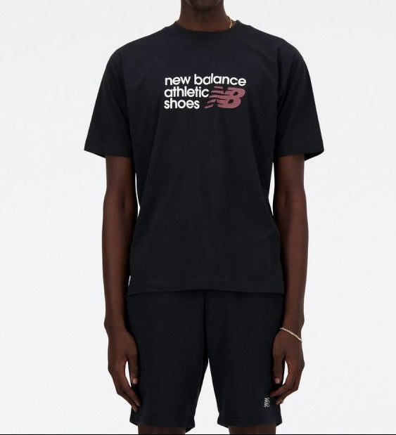 Person wearing a black New Balance t-shirt on a white background