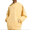 Person wearing a yellow hoodie on a white background