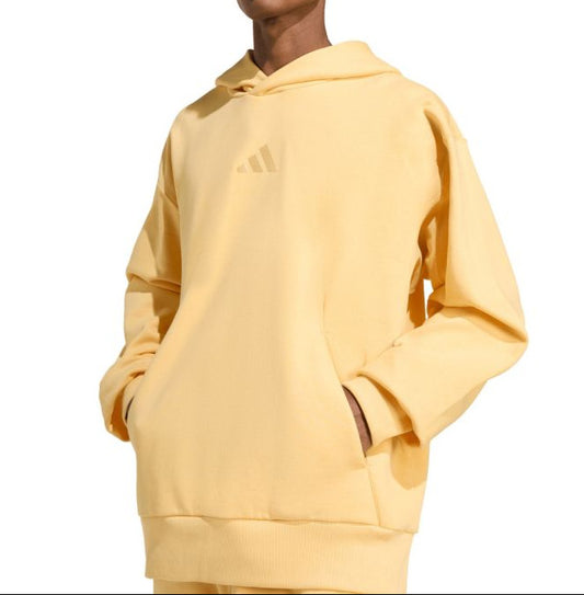Person wearing a yellow hoodie on a white background
