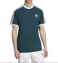 Person wearing a green Adidas t-shirt with white stripes on a white background
