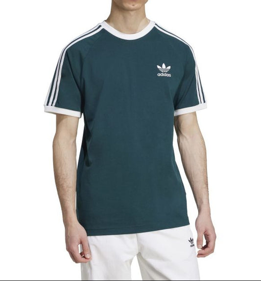 Person wearing a green Adidas t-shirt with white stripes on a white background